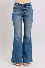 Flared vintage wash jeans with tummy control feature, perfect for stylishly flattering outfits.