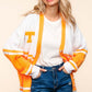 Woman wearing Haptics V Neck Button Down Letter Patch Cardigan in orange and white with a relaxed fit