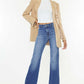 Fashion-forward woman in Ultra High Waist Gradient Flare Jeans with a beige blazer and white top, showcasing chic and trendy denim style