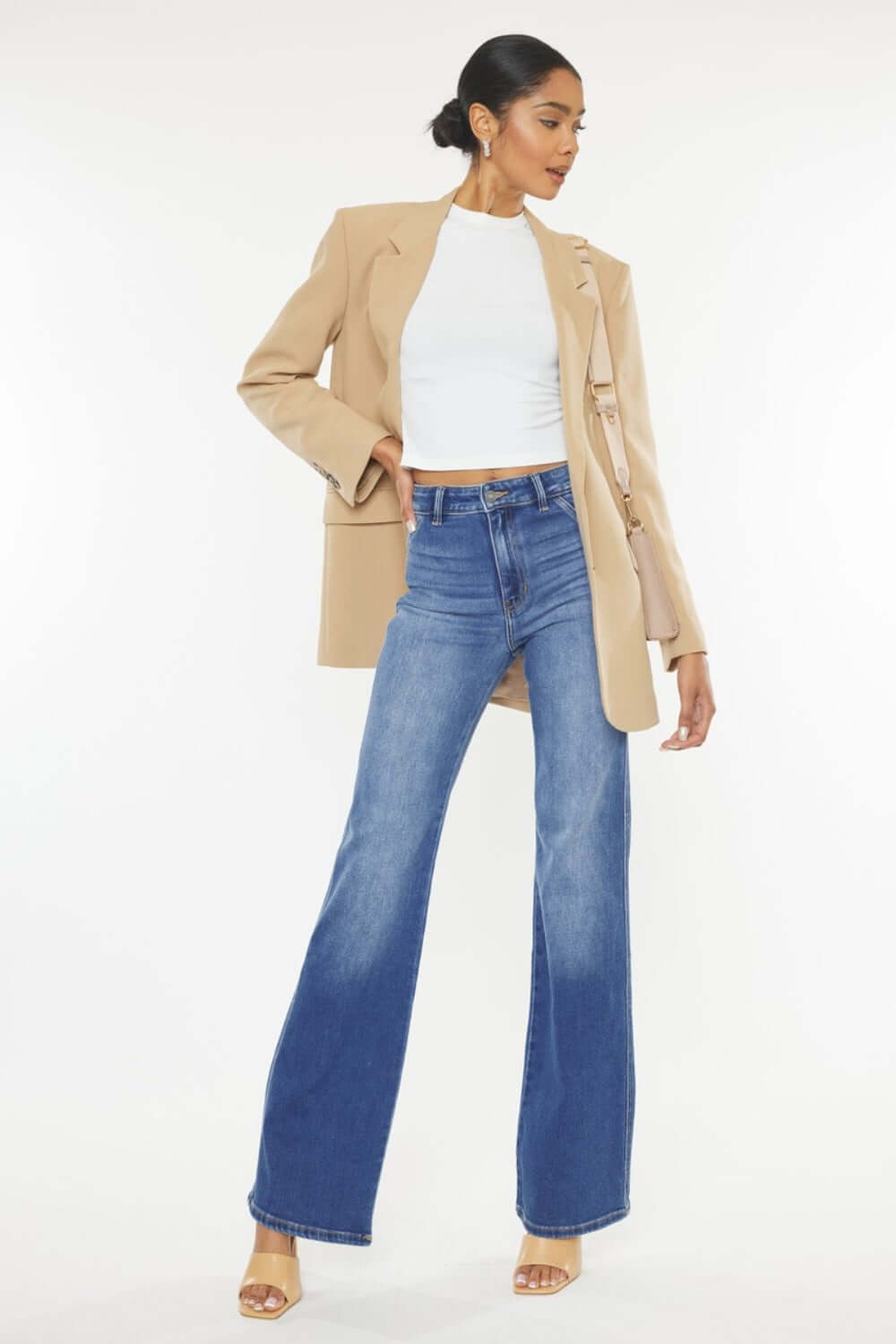 Fashion-forward woman in Ultra High Waist Gradient Flare Jeans with a beige blazer and white top, showcasing chic and trendy denim style