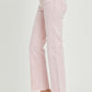 High-rise pink straight jeans with raw hem detail and tummy control feature for a flattering fit, shown on a model with clear heels.