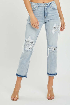 Mid-rise sequin patched jeans by Risen Jeans with ripped knees and rolled cuffs, featuring stylish sparkly patches.