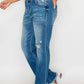 Raw hem distressed mid-rise straight jeans styled with a casual top and strappy sandals, perfect for any occasion.