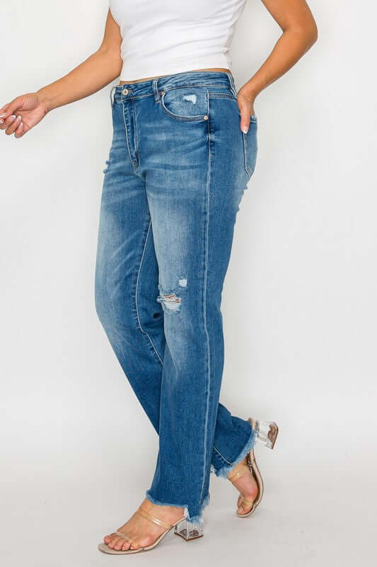 Raw hem distressed mid-rise straight jeans styled with a casual top and strappy sandals, perfect for any occasion.