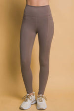 High waist brown leggings with side pockets, perfect for workouts and casual outings. Stylish and comfortable fit.