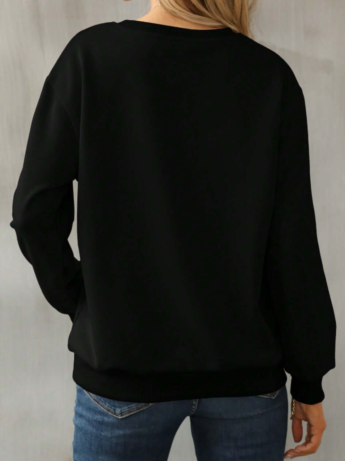 Back view of Bella Road Yellowstone Round Neck Long Sleeve Sweatshirt in black, showcasing cozy style and comfortable fit.