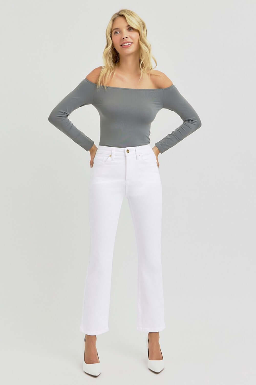 Woman modeling RISEN full size tummy control elastic band high rise crop straight jeans in white.