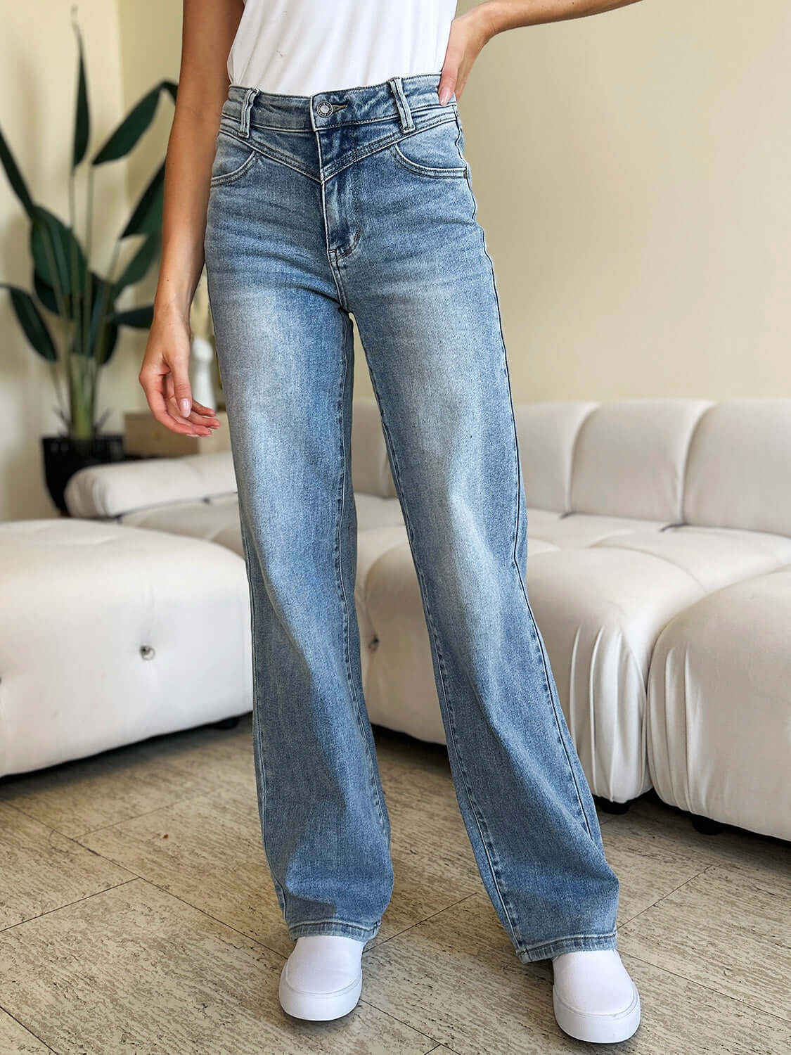 Woman wearing High Waist Wide Leg Judy Blue Jeans standing in a modern living room