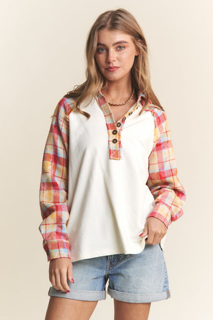 Woman wearing J.NNA plaid contrast button-down henley top with denim shorts, showcasing a chic and trendy casual look.