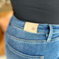 Close-up of RFM Full Size High Rise Tummy Control Wide Leg Jeans illustrating high-waist design and back pocket details.