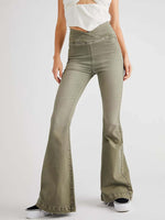 Woman wearing Asymmetric Waist Flare Jeans in green standing.