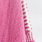 Close-up of pink Double Take Contrast Cardigan showing knit texture and contrasting white stripe detail