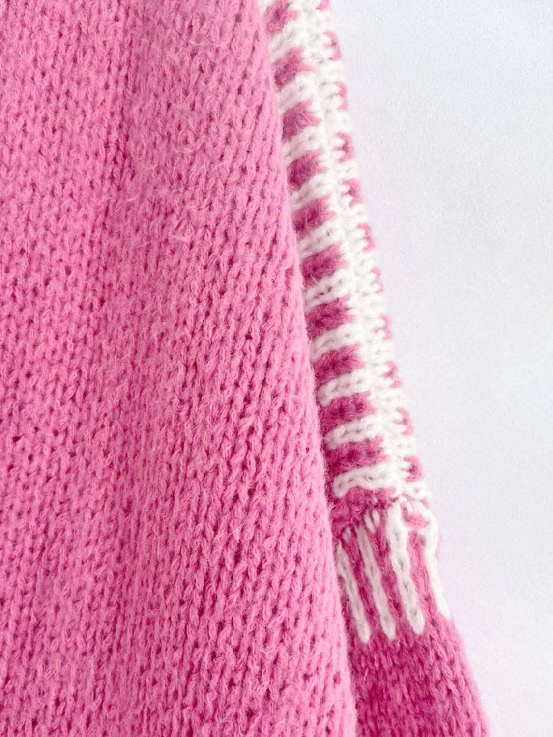 Close-up of pink Double Take Contrast Cardigan showing knit texture and contrasting white stripe detail