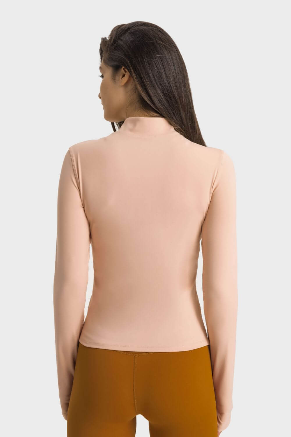 Back view of the Millennia Half Zip Thumbhole Sleeve Sports Top in soft peach, perfect for workouts and yoga sessions.