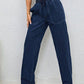 Woman wearing Bella Road Drawstring Elastic Waist Jeans with Pockets, showcasing comfortable fit and stylish design