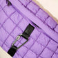 Stylish purple bubble texture quilted sling bag with carabiner clip, perfect for carrying essentials.