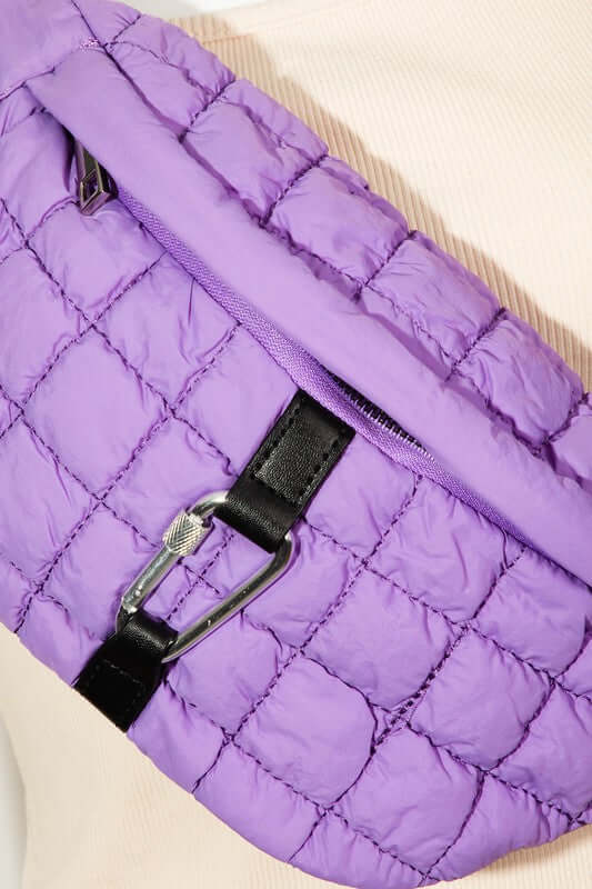 Stylish purple bubble texture quilted sling bag with carabiner clip, perfect for carrying essentials.