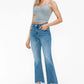 Model wearing bytos Raw Hem Distressed Mid Rise Crop Jeans with a gray crop top, showcasing modern denim style.