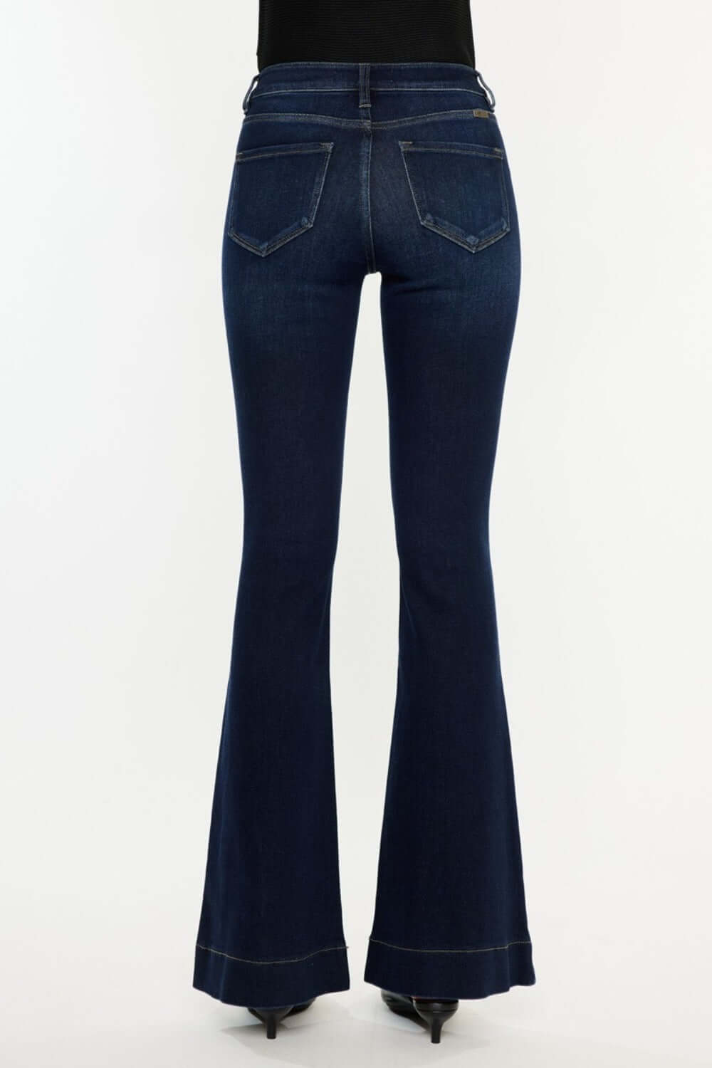 Back view of Kancan High Rise Slim Flare Jeans in dark stone wash, showcasing pocket detailing and flared legs for a chic style.