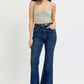 Woman wearing RISEN Tummy Control High Rise Flare Jeans with Frayed Hem belt, showcasing retro-inspired style and enhanced tummy control.