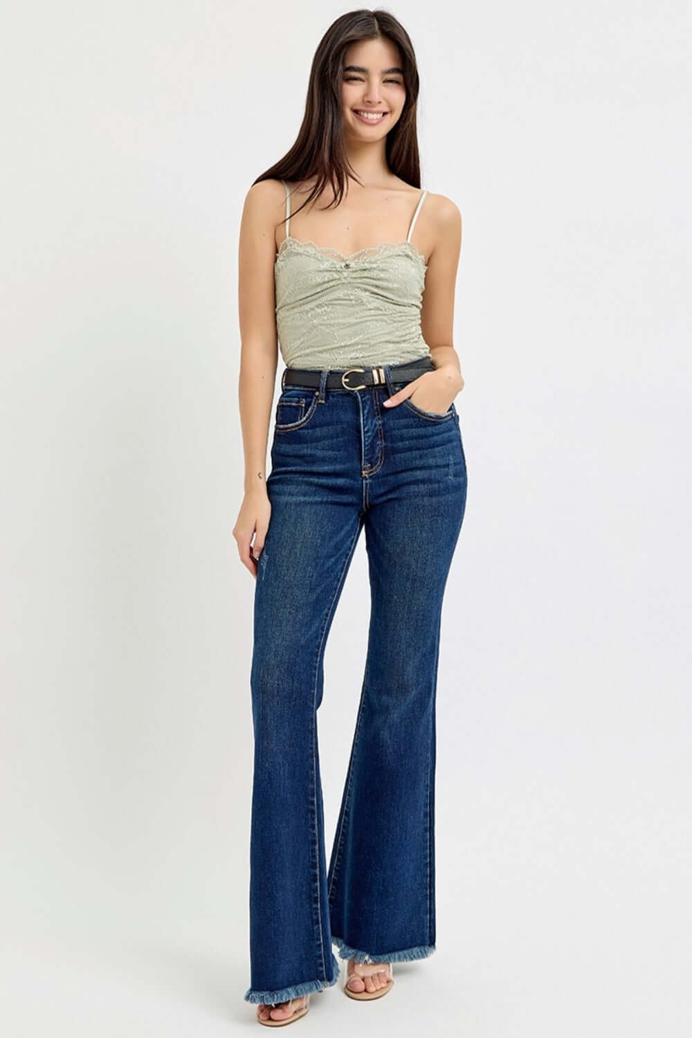 Woman wearing RISEN Tummy Control High Rise Flare Jeans with Frayed Hem belt, showcasing retro-inspired style and enhanced tummy control.