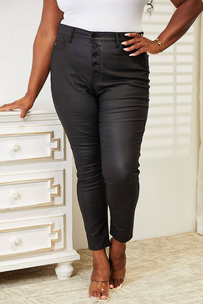 High Rise Black Coated Ankle Skinny Jeans with Exposed Button Closure, Figure-Hugging Fit, and Sleek Glossy Finish