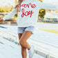 Woman wearing Bella Road Game Day Round Neck Long Sleeve Sweatshirt outdoors near a track.