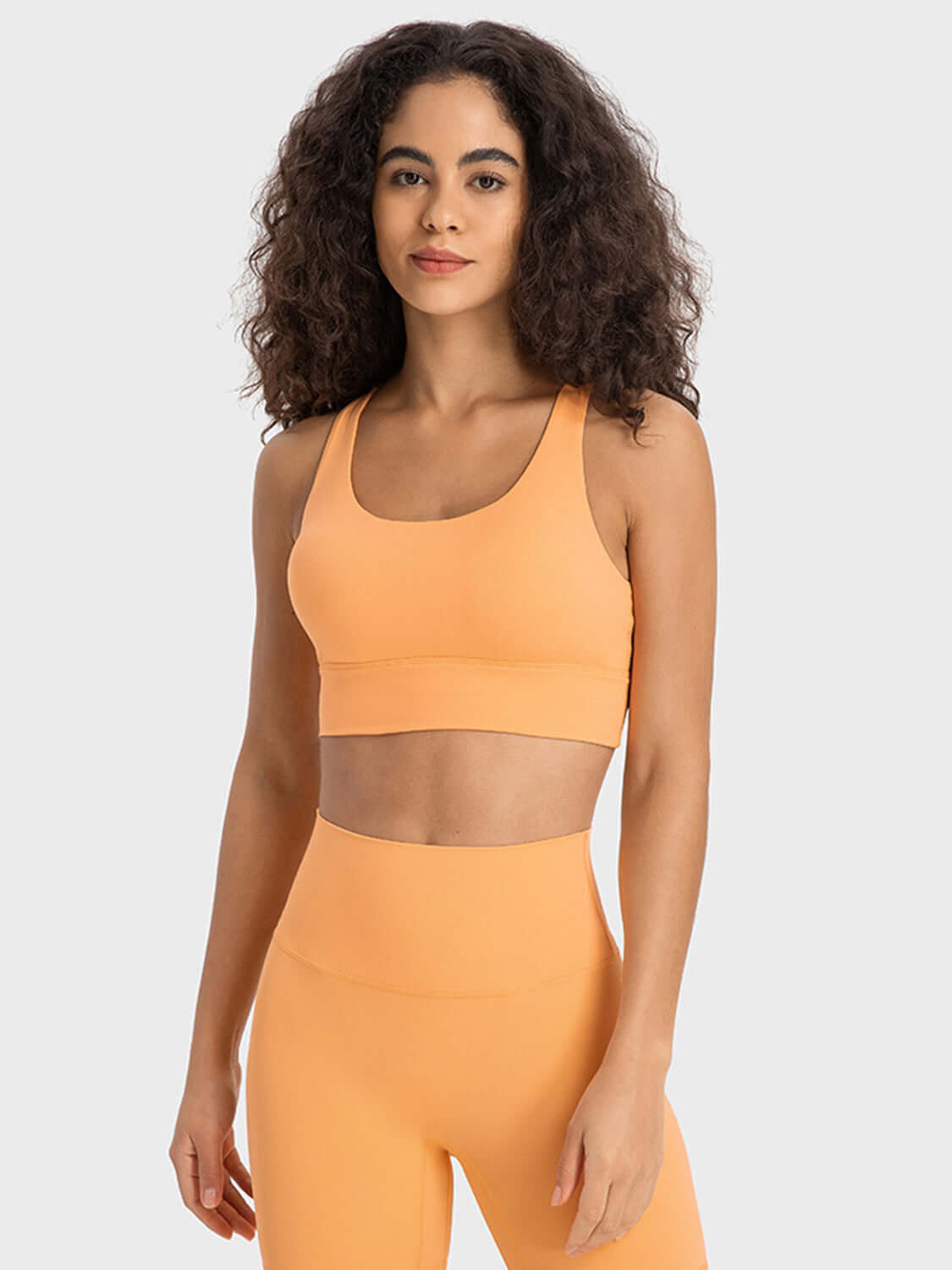 Millennia Crisscross Scoop Neck Active Tank in vibrant orange, showcasing style and comfort for workouts.