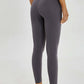 Woman showcasing the Millennia Wide Seamless Band Waist Sports Leggings in gray, perfect for workouts and daily wear.