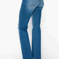 Woman showcasing bytos raw hem distressed mid rise straight jeans from the back, highlighting the edgy style and flattering fit.