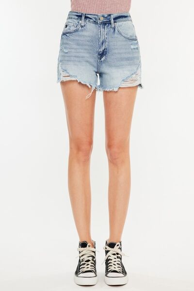 Kancan distressed high waist denim shorts with raw hem and pockets, styled with sneakers.