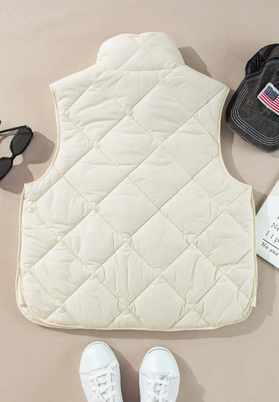 Ivory Bella Road Snap Down Texture Vest Coat with pockets displayed alongside accessories for a stylish look.