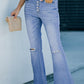 Woman wearing Bella Road Button-Fly Distressed Raw Hem Flare Jeans with slightly stretchy fabric and holding a beige clutch