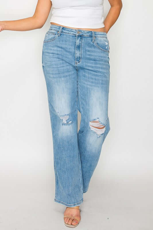 Woman showcasing bytos Full Size Distressed High Rise Straight Jeans with stylish rips and relaxed fit in light blue.