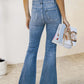 Woman wearing Bella Road slit bootcut jeans with pockets, holding magazines.