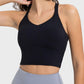 Crisscross round neck active tank in black, featuring moderate stretch and sleek design for workouts and casual wear.