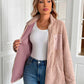 Woman wearing Ivy Lane Zip Up Long Sleeve Fuzzy Jacket in pink, paired with white top and jeans, showcasing cozy style.