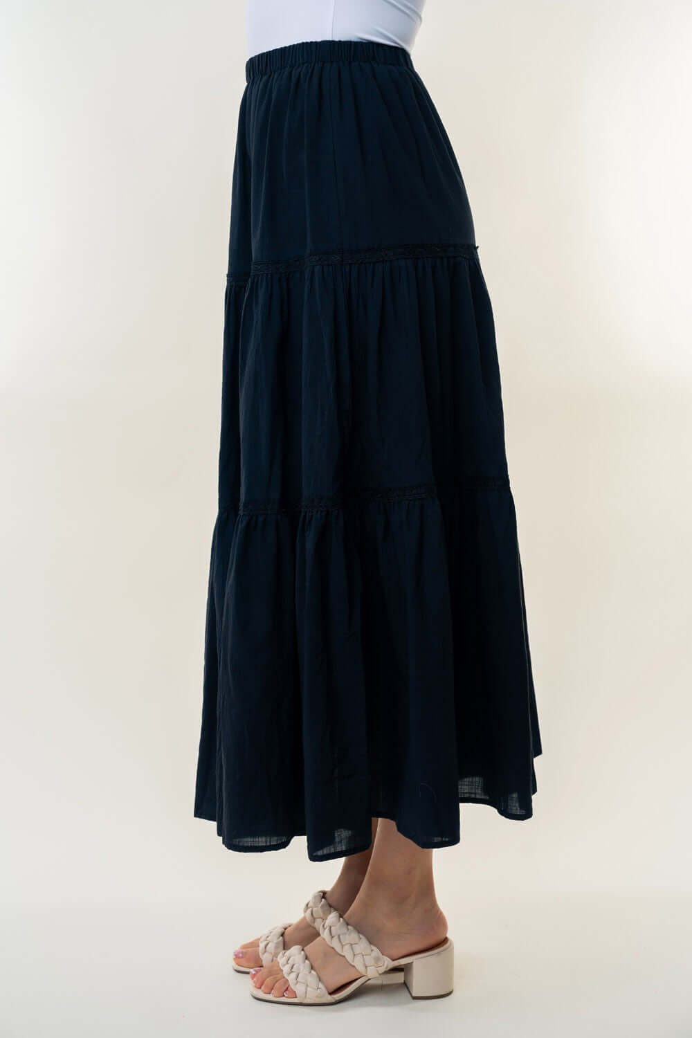 High Waisted Tiered Maxi Skirt in black with a flowy feminine silhouette, featuring a high-rise waist and multiple tiers of fabric.