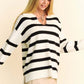 Woman modeling a Davi & Dani high-low striped Johnny collar sweater with side slits and a chic, relaxed fit.