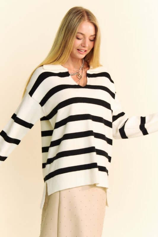 Woman modeling a Davi & Dani high-low striped Johnny collar sweater with side slits and a chic, relaxed fit.