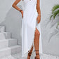 Woman wearing backless tassel surplice spaghetti strap cover-up dress in white with side slit, styled with sandals and bracelets.