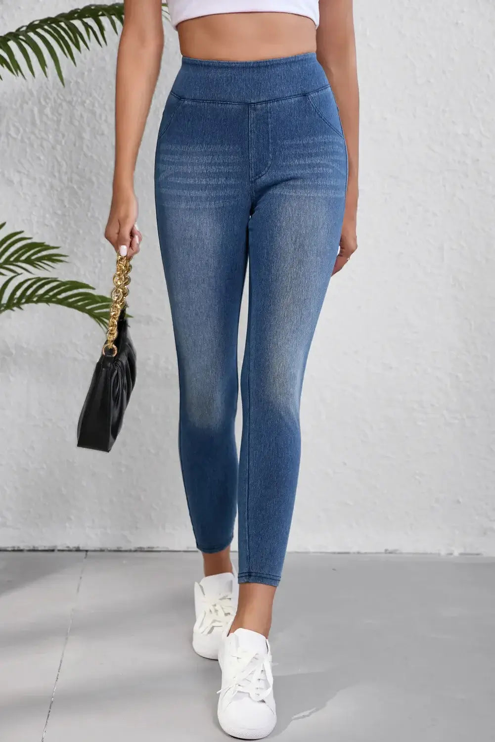 High waist skinny jeans on model showcasing flattering fit and moderate stretch for stylish and confident look