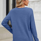 Woman wearing Bella Road Waffle-Knit Notched Long Sleeve T-Shirt in blue, viewed from the back.