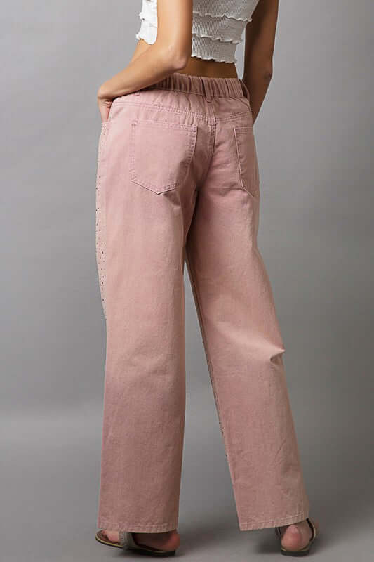 Back view of stylish pastel pink POL Embellishments Gradient Wide Leg Pants with pockets and decorative details.