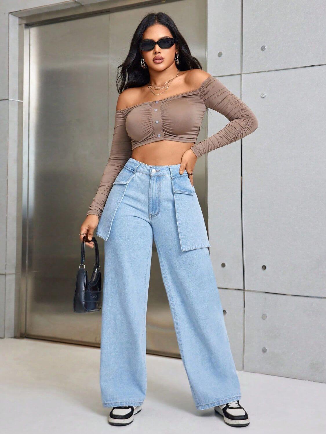 Woman wearing Bella Road Wide Leg Jeans with Pockets, brown crop top, and sunglasses, posing confidently in front of an elevator.