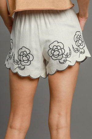 Back view of Umgee linen blend shorts with floral embroidery and scalloped hem, perfect for summer style.