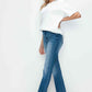 Woman wearing bytos distressed high rise jeans, showcasing casual style with a white top and trendy fit.