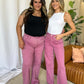 Two women wear stylish pink RFM Full Size High Rise Garment Dye Wide Leg Jeans, showcasing a relaxed, chic look with a soft, lived-in feel.