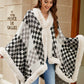 Woman wearing Bella Road Fuzzy Checkered Long Sleeve Poncho in black and white, showcasing cozy style and warmth for fall.