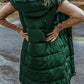 Woman wearing green Bella Road Longline Hooded Sleeveless Puffer Vest, showing back view and versatile layering style.